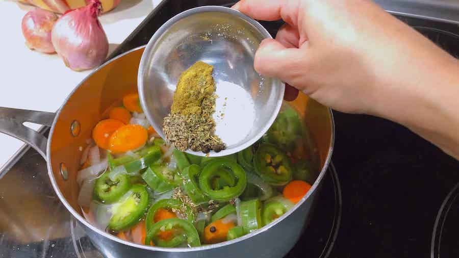 adding spices to vinegar mixture and veggies