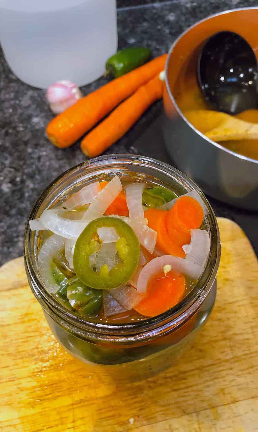 ladling hot vegetables into jars