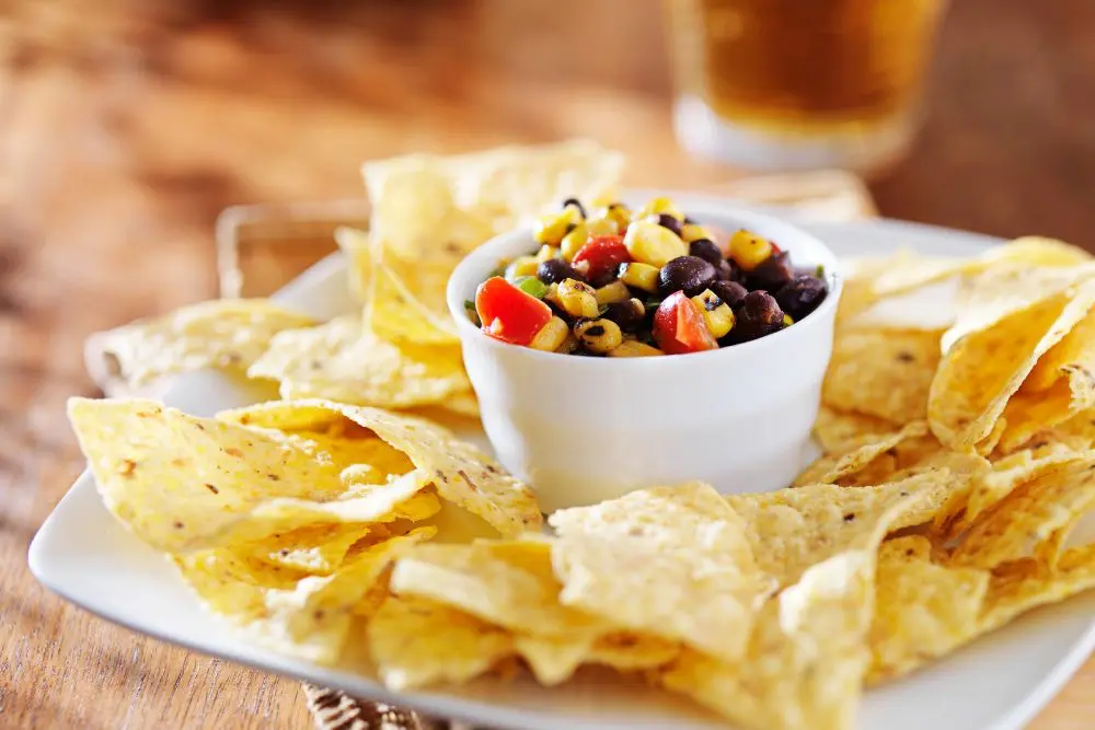 black bean and corn salsa wth chips on plate