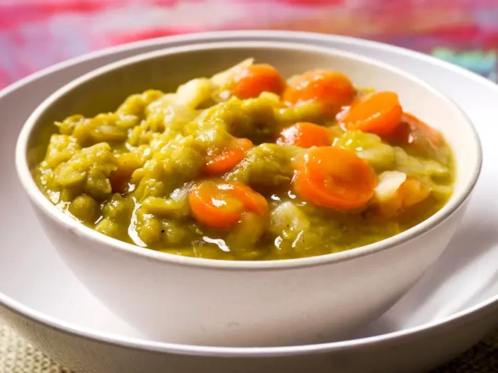 split pea soup with carrots in white bowls