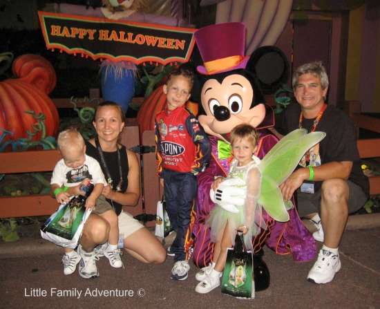 family with children dressed Halloween costumes with Mickey Mouse during Mickey's Not So Scary Halloween Party