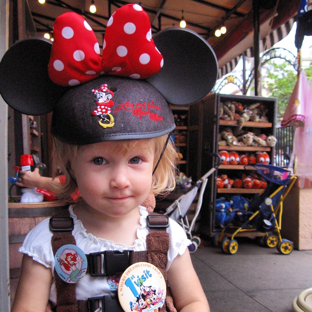 2 year old girl at Disney World sporting Minnie ears and 1st visit button