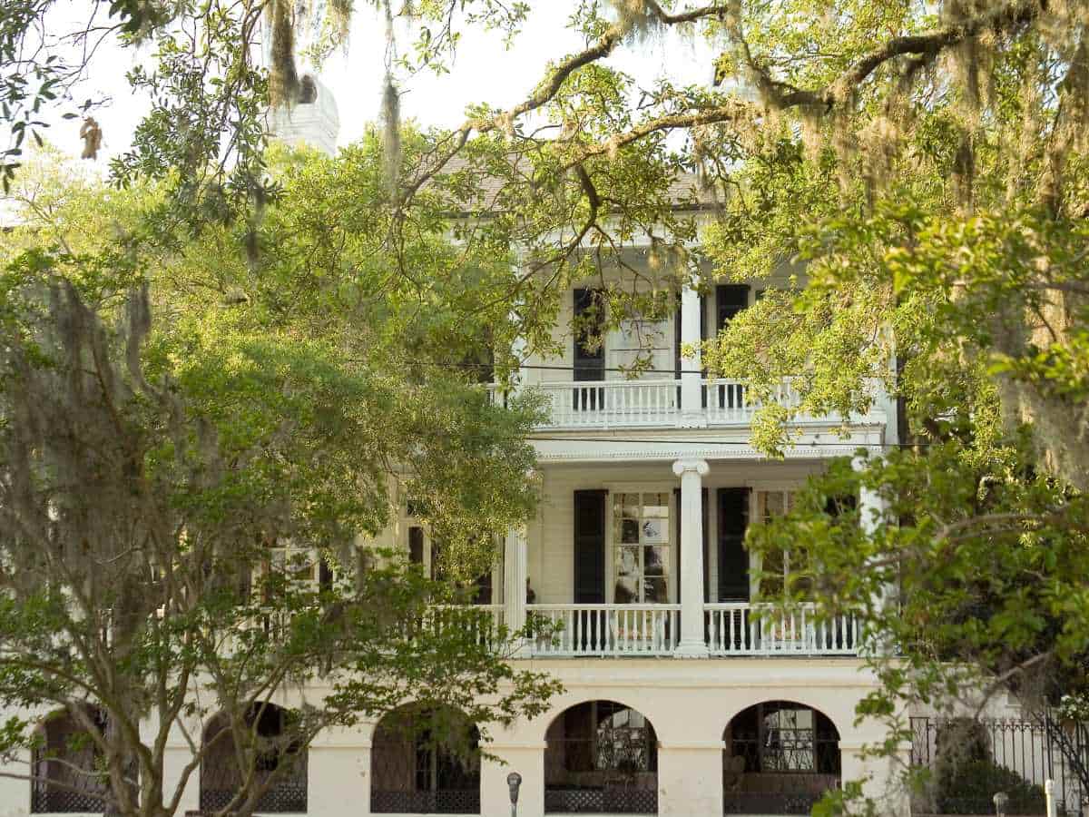 historic home framed with green leaf trees in beaufort south carolina