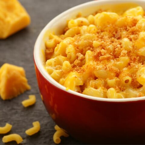 baked mac and cheese in bowl with cheese side