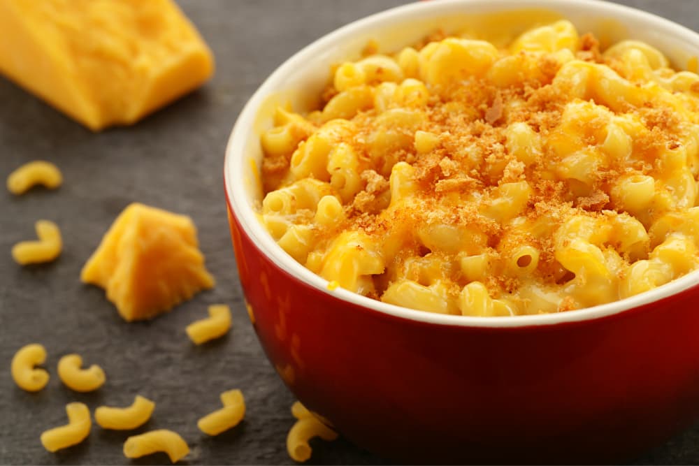 baked mac and cheese in bowl with cheese side