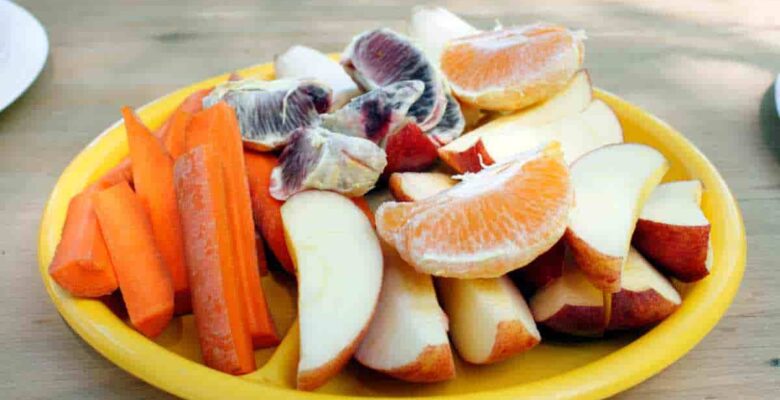 cut up fresh fruits and vegetables on a plate