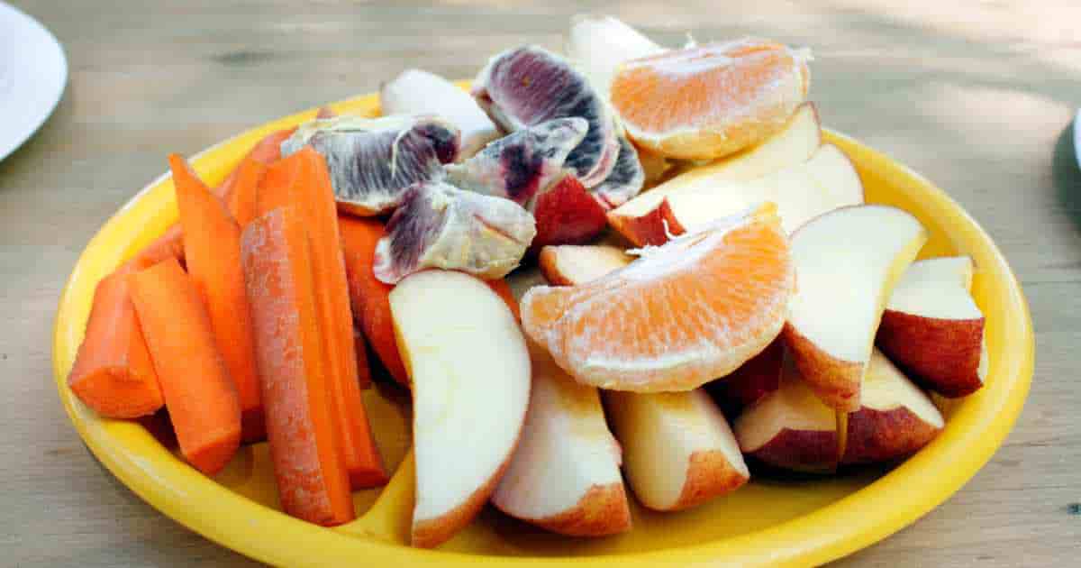 cut up fresh fruits and vegetables on a plate