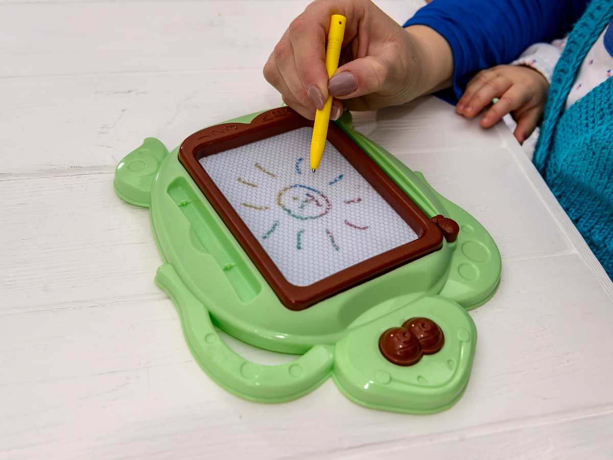 magnetic drawing board with stylus as activity for toddler on an airplane
