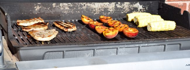 Spicy Grilled Pork Chops with Cinnamon Peaches and Corn on the Cob - Grilling is made easy with @ALDIUSA. They have everything you need to fire up the grill and save you money on groceries too. #summergrilling #ad #campfood