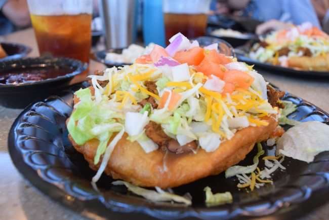 Indian Taco - fry bread topped with beef, lettuce, cheese, and tomato