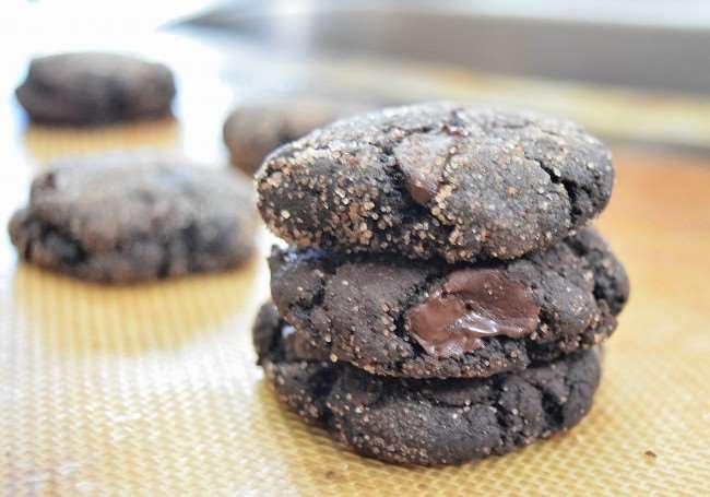 Chocolate cookies stacked on silicone mat