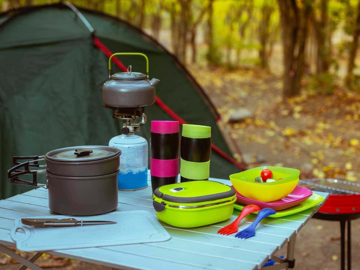 cookset and dishes with tent in background for gifts for campers