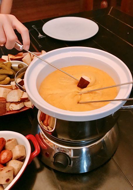 dipping bread in Cheddar Cheese  Fondue