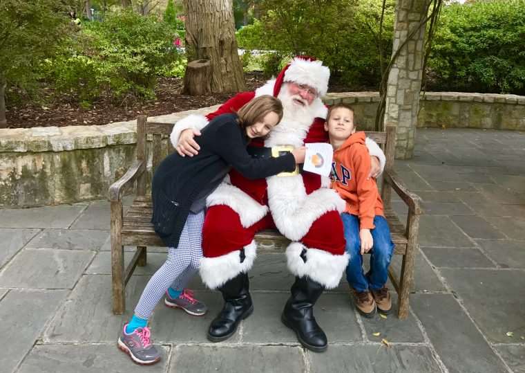 boy and girl on a bench with Santa in Dallas