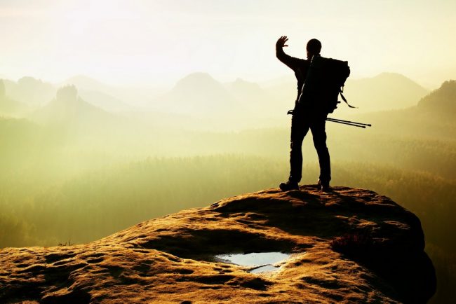 Man at the top of a peak