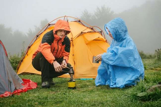 Campers staying dry in rain jackets - Things to remember when Spring Camping with Your Family