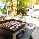 flattop griddle cooking breakfast outdoors in front of RV