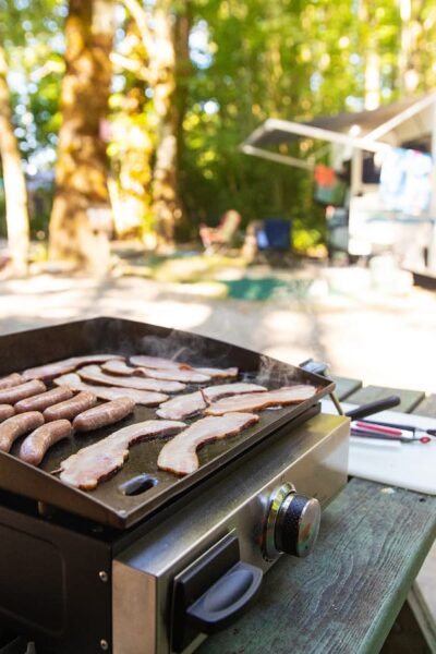 flattop griddle cooking breakfast outdoors in front of RV