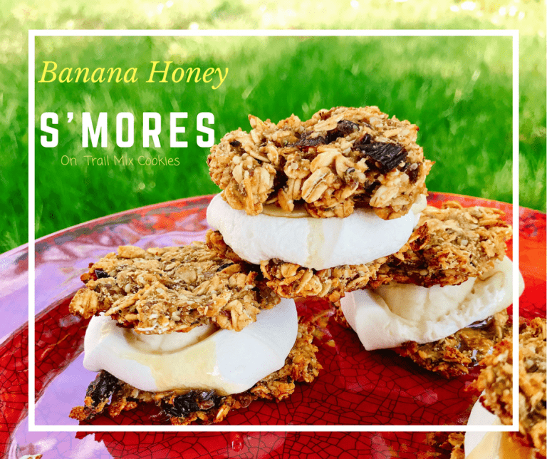 Instead of classic S'mores, mix things up with these gluten free Banana Honey S'mores on Trail Mix cookies. These camping snacks/desserts are vegan and made without refined sugar. Made with Wedderspoon Manuka Honey. Kids and adults eat them up.