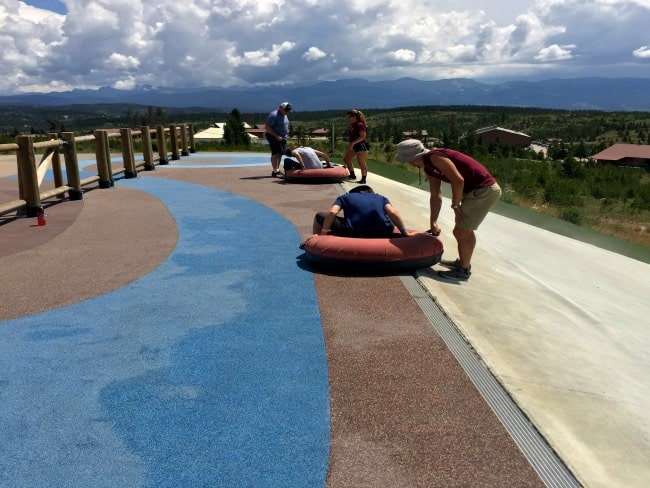 Summer tubing at YMCA of Rockies Snow Mountain Ranch. Just like snow tubing only in shorts. Fun for the whole family! Awesome mountain views and a magic carpet ride back up the hill to save your oxygen! Part of the YMCA Snow Mountain Ranch Family Fun Park. Come an play all day!