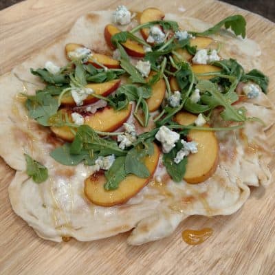 Peach & Honey Pizza made in an outdoor CampMaid Dutch Oven