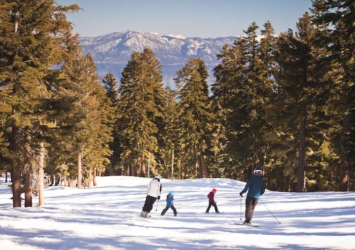 Family Skiing Down Mountain