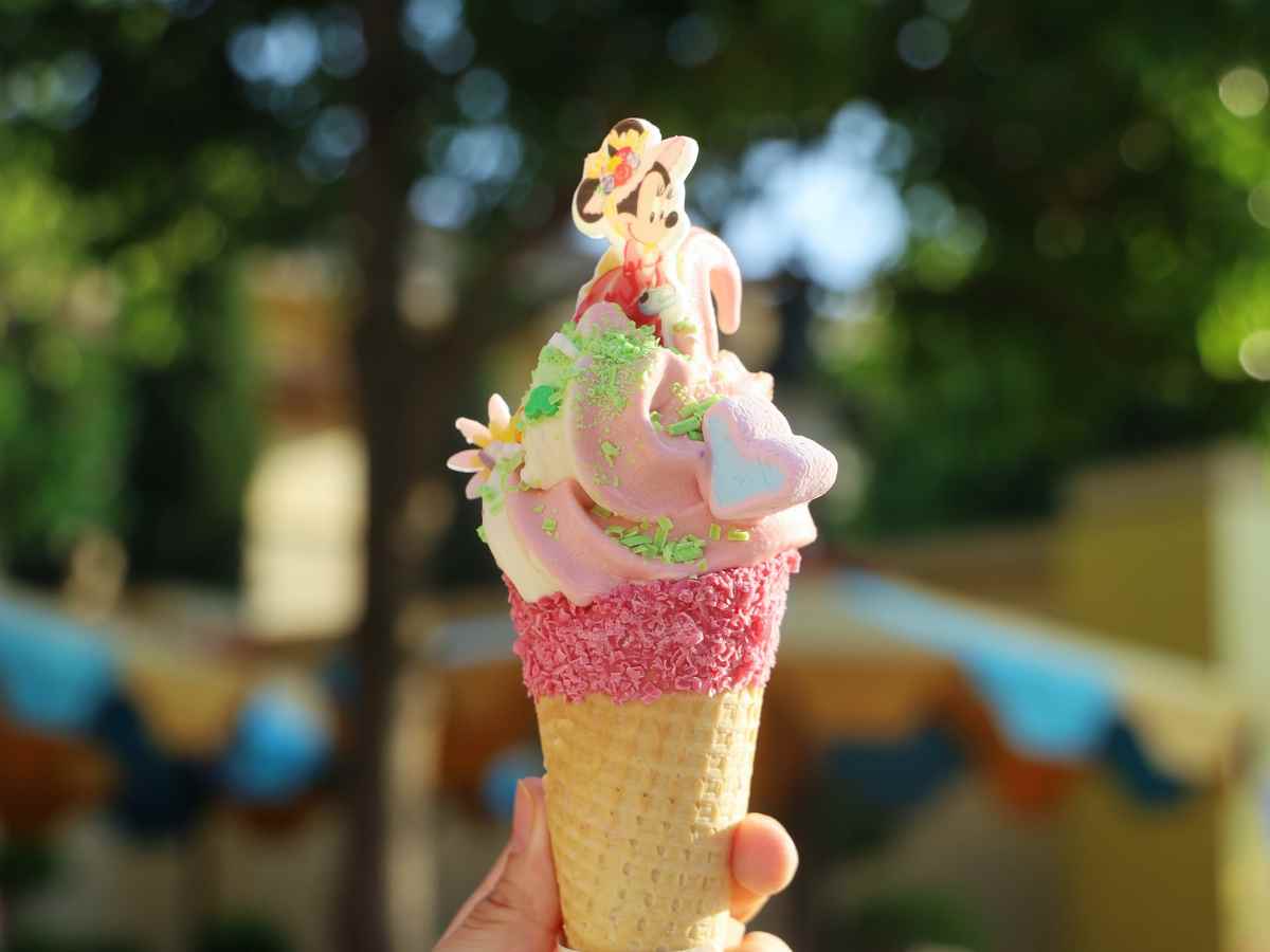 ice cream cone with disney decorations and pink sprinkles