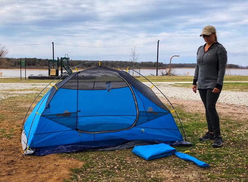 Setting up a tent near the lake. 