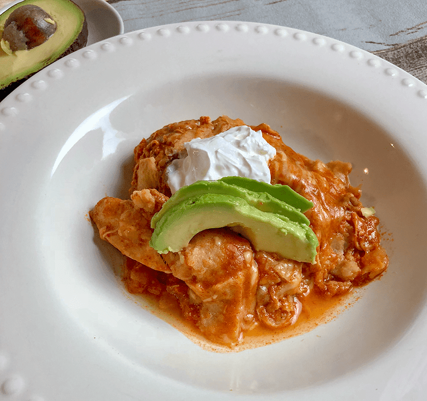 Chicken enchiladas with avocado and sour cream