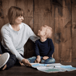 Mother and children looking at a map - Tips to Planning International Travel with Children as a Single Parent - Easy ways to plan your next trip aboard when your partner/spouse is staying home.