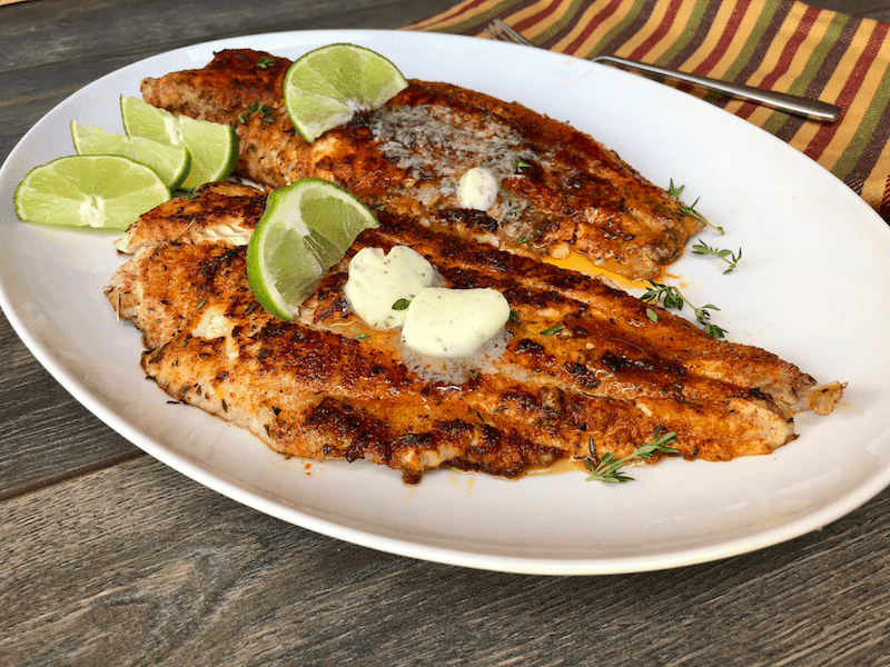 Blackened Catfish with Herbed Garlic Butter is a great alternative to fried catfish. With homemade blackened seasoning, this is a spicy option for the camp fire, grill, or cast iron skillet.