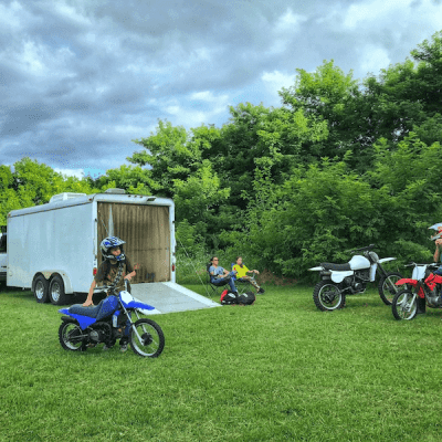 boys on dirt bikes and the family sits back to relax, trailer hauled with a B&W trailer hitch