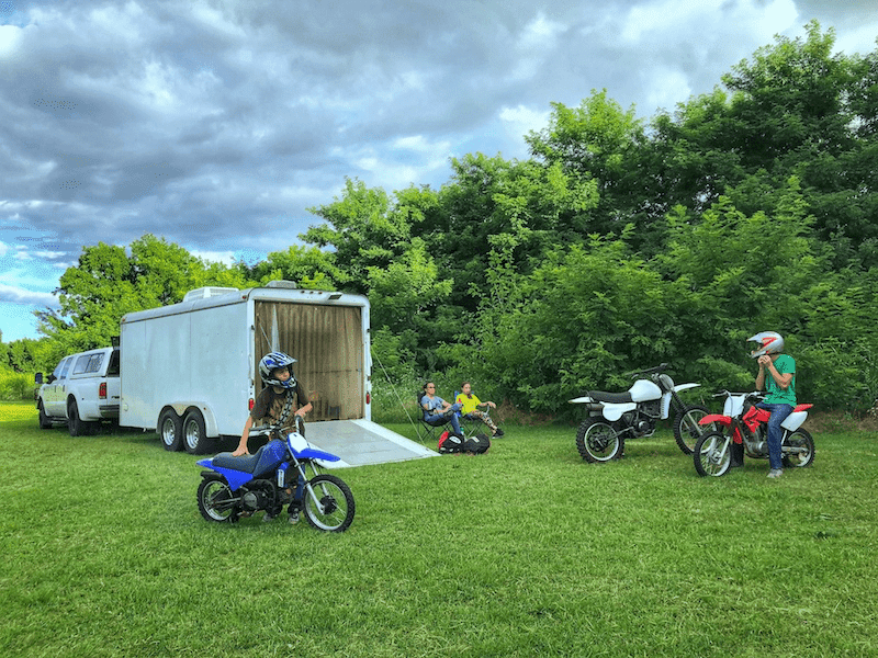 boys on dirt bikes and the family sits back to relax, trailer hauled with a B&W trailer hitch