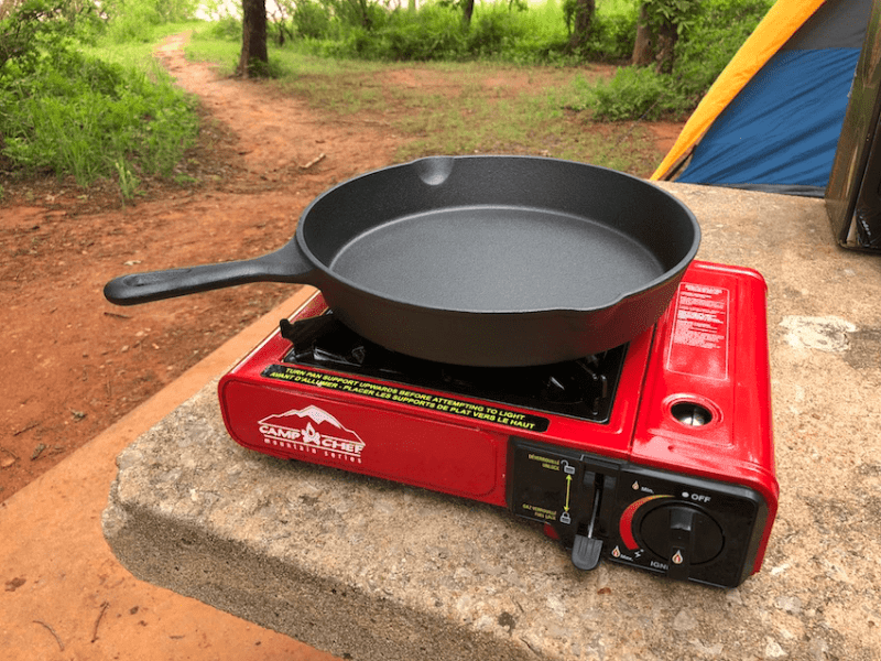 Camp Chef Butane camping stove and cast iron skillet - Ensure Your Next Family Camping Trip is Epic with these Summer Planning Tips