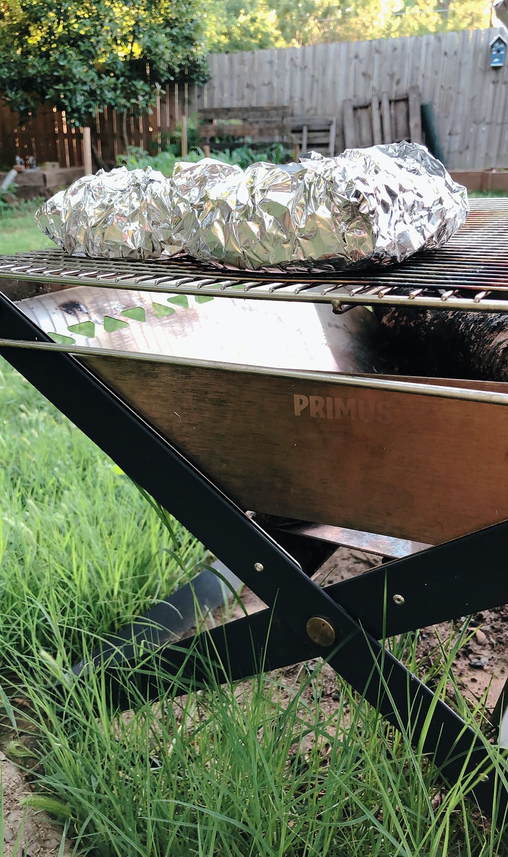 foil packets on a grill over firepit