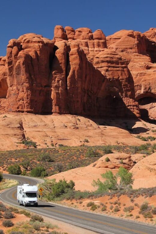 rv driving through red rock canyon