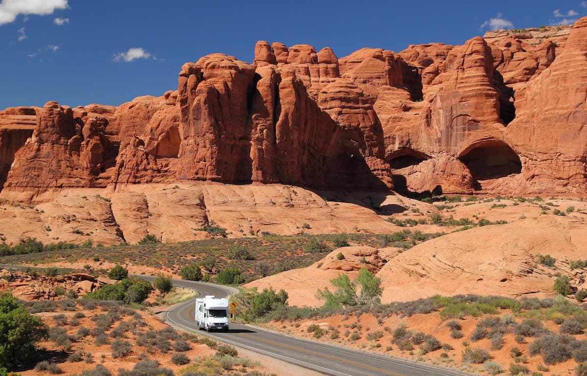 rv driving through red rock canyon