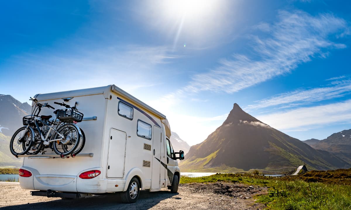 RV on dirt road with bicycles on back