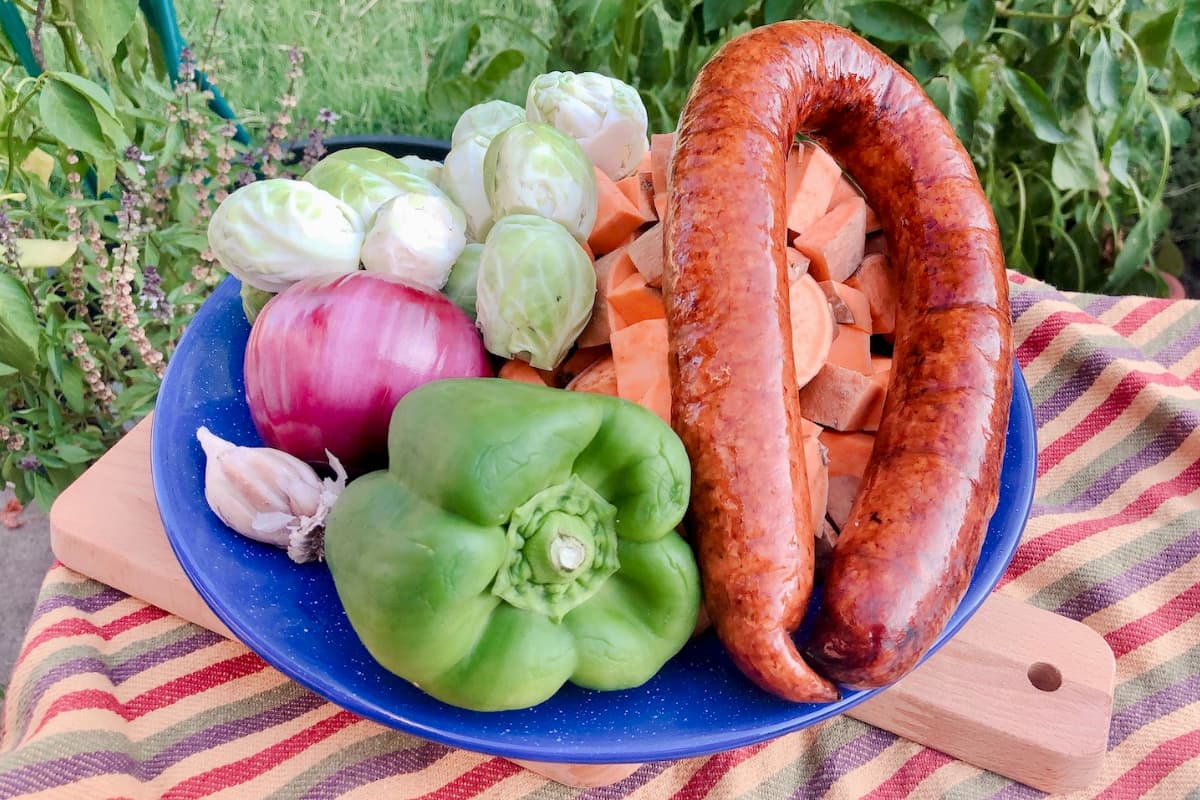 sausage, bell pepper, onion, brussels sprouts on plate