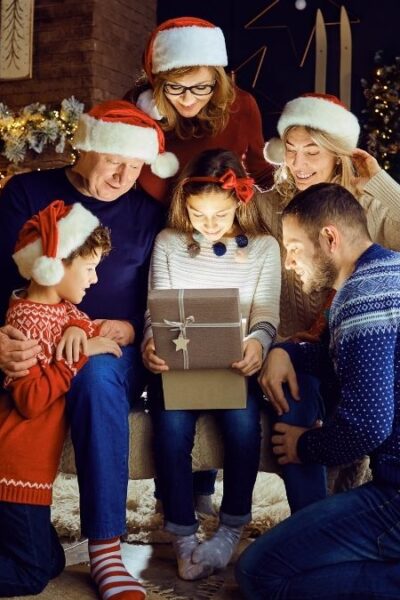 family opening up one shiny gift