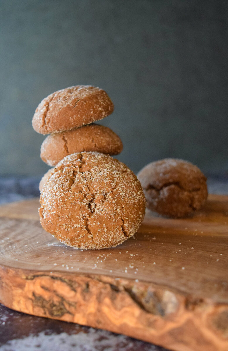 molasses crinkle cookies stacked on wooden board