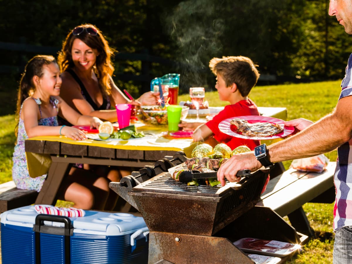 family camping, eating at picnic table