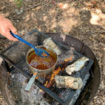 food cooking over camp fire