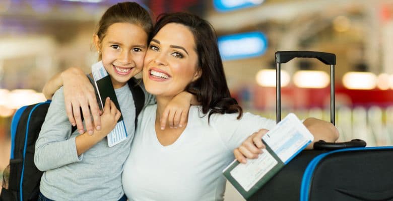 mother and daughter with passports and tickets in hand