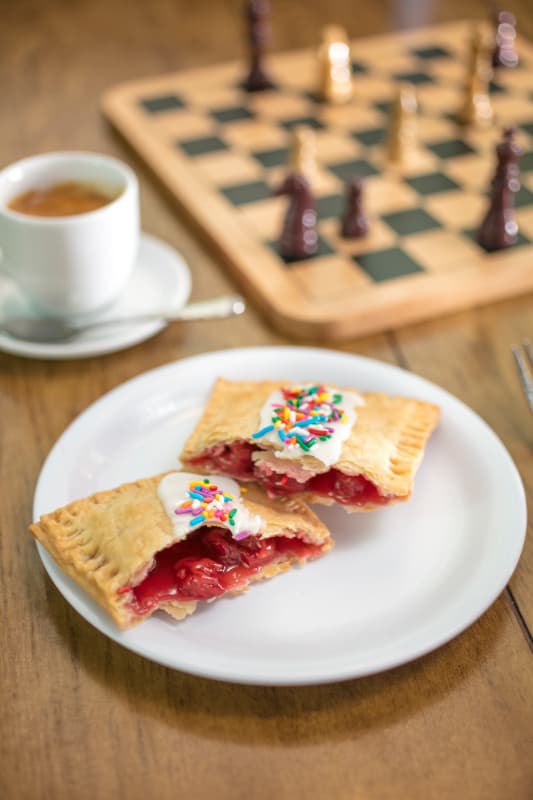 homemade pop tart with coffee and chess game in background