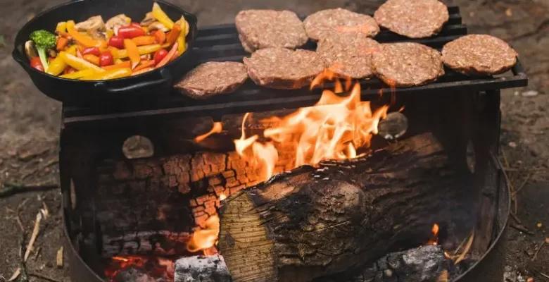 burgers and peppers over campfire