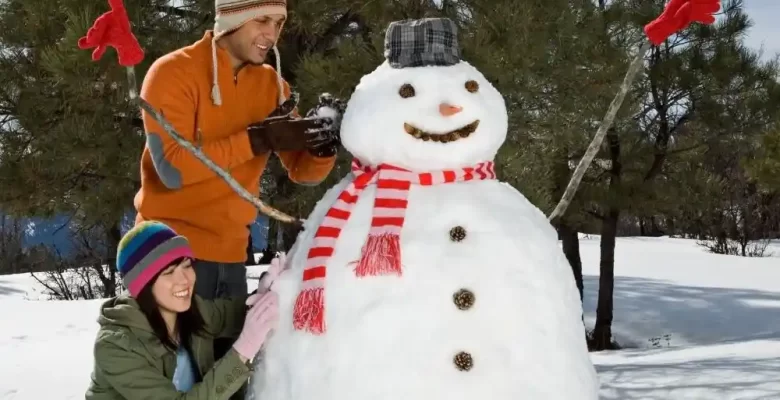 couple building snowman