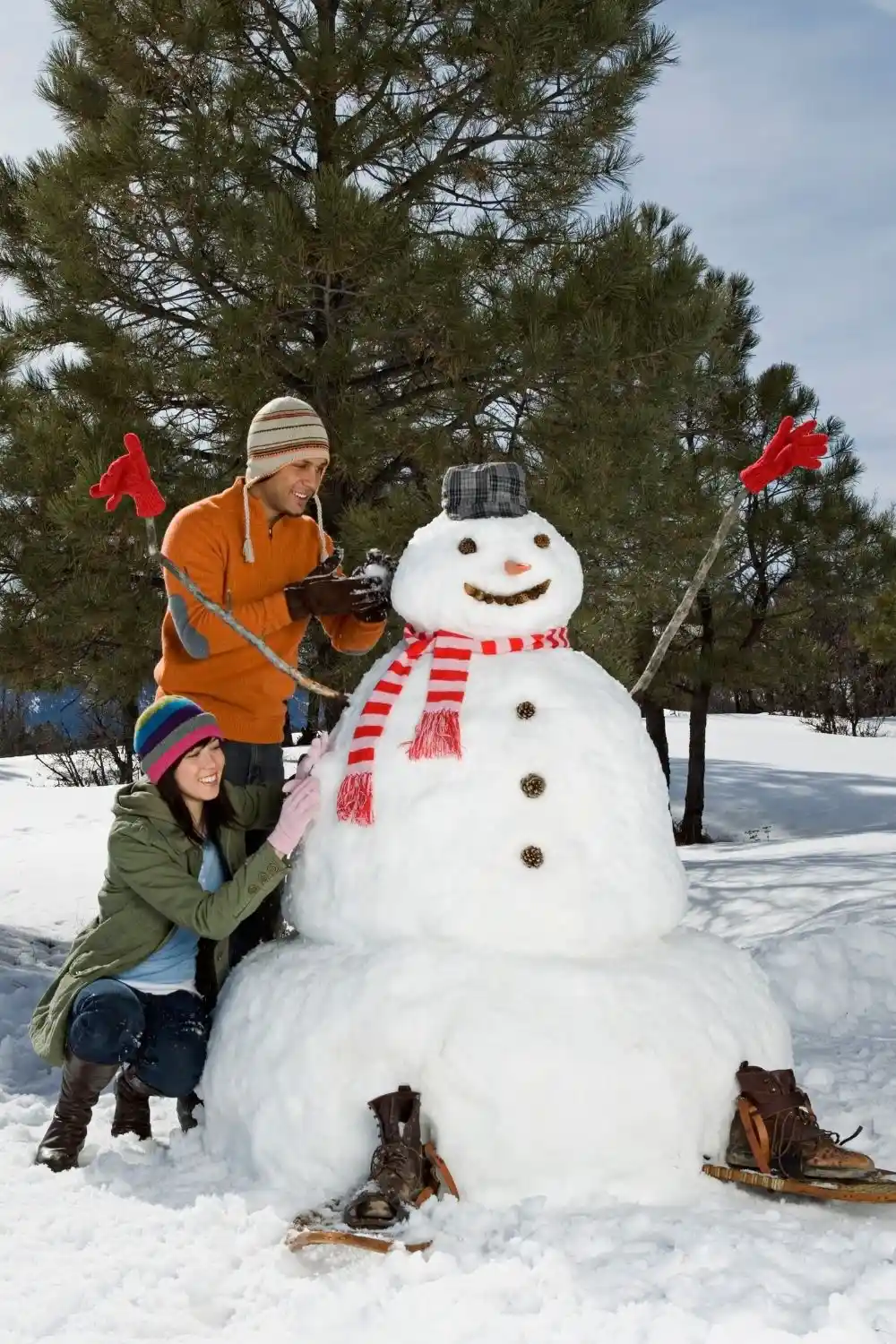 couple building snowman