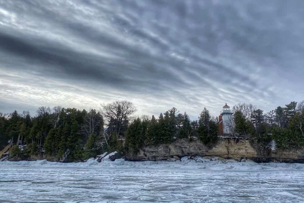 Frozen lake overlooking lighthouse