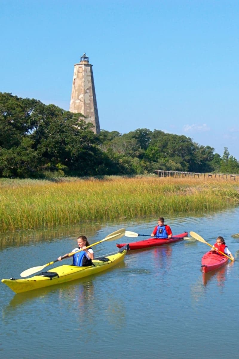 family kayaking on waterway
